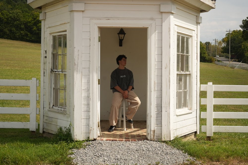 Ryan sitting in a white gazebo, shot on a tripod